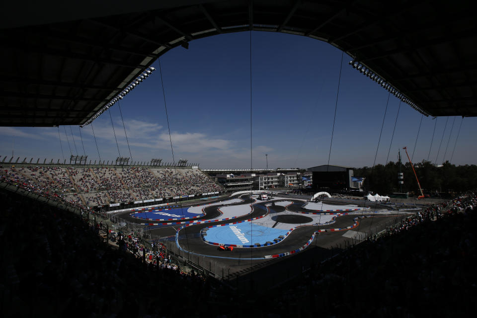 Fans watch the competition from the stands as IndyCar driver Josef Newgarden, of the U.S., front, races against World Rallycross driver Johan Kristoffersson, of Sweden, during the Race of Champions at Foro Sol in Mexico City, Sunday, Jan. 20, 2019. The Race of Champions is being held for the first time in Latin America. (AP Photo/Rebecca Blackwell)