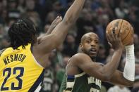 Milwaukee Bucks' Khris Middleton tries to get past Indiana Pacers' Aaron Nesmith during the first half of Game 1 of the NBA playoff basketball game Sunday, April 21, 2024, in Milwaukee. (AP Photo/Morry Gash)