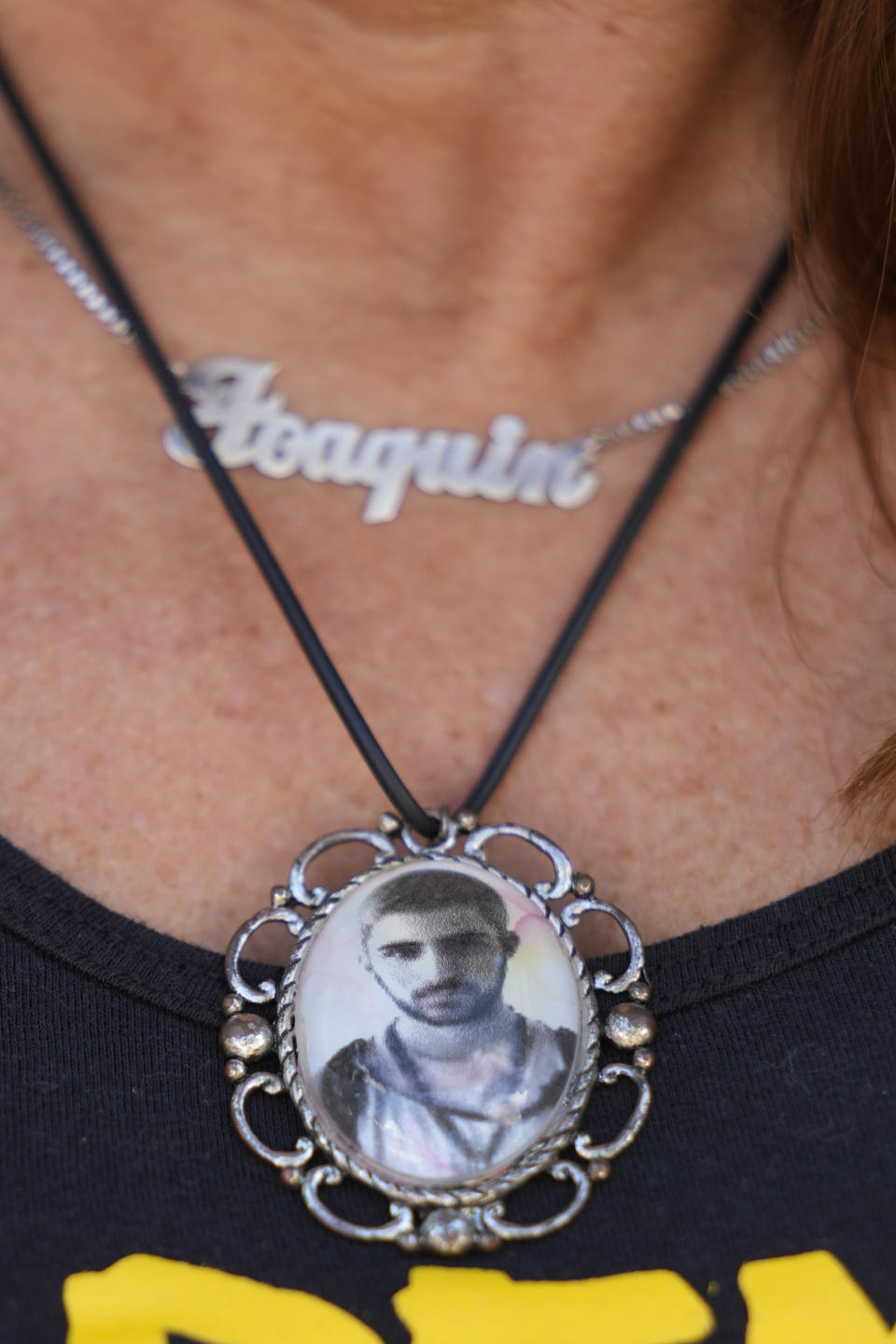 Patricia Oliver wears a pendant with a photo of her son, Joaquin, during an interview, Monday, Jan. 30, 2023, at her home in Coral Springs, Fla. Her 17-year-old son was killed at Parkland's Marjory Stoneman Douglas High School shooting five years ago. Oliver and her husband Manuel started a foundation, Change the Ref, to challenge the political influence of the National Rifle Association and gun manufacturers. (AP Photo/Wilfredo Lee)