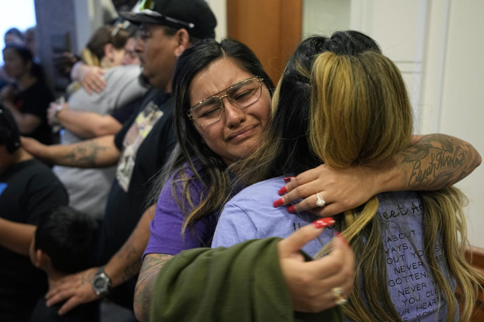 FILE - Family members of the victims of the Uvalde shootings react after a Texas House committee voted to take up a bill to limit the age for purchasing AR-15 style weapons in the full House in Austin, Texas, Monday, May 8, 2023. Families in Uvalde, Texas, are digging in for a new test of legal protections for the gun industry as they mark one year since the Robb Elementary School shooting. Both the U.S. government and gun manufacturers in recent years have reached large settlements following some of the nation's worst mass shootings. (AP Photo/Eric Gay, File)