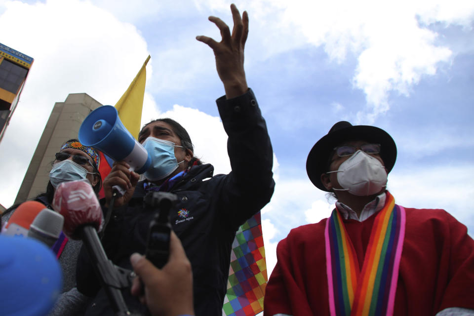 Yaku Perez, presidential candidate of the Pachakutik political party, talks into a bullhorn outside the National Electoral Council in Quito, Ecuador, Thursday, Feb. 11, 2021. Perez and his supporters are demanding observers be vigilant of the vote count as the second slot for the upcoming presidential runoff remains undecided between former banker Guillermo Lasso and Perez, an Indigenous rights and environmental activist. (AP Photo/Dolores Ochoa)