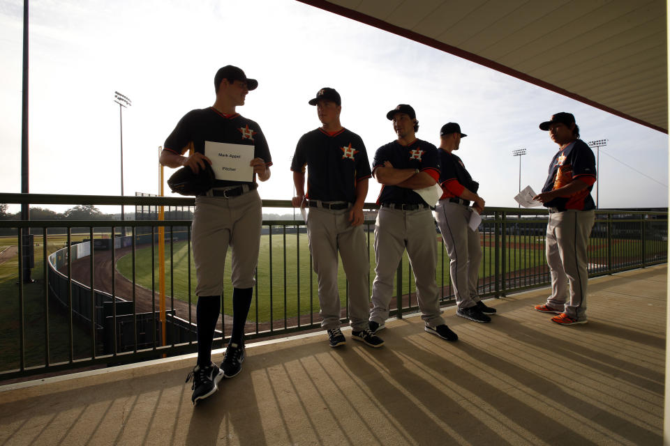 Houston Astros pitcher Mark Appel, left, and others, line up to have their picture taken on photo day at their spring training baseball facility, Friday, Feb. 21, 2014, in Kissimmee, Fla. (AP Photo/Alex Brandon)