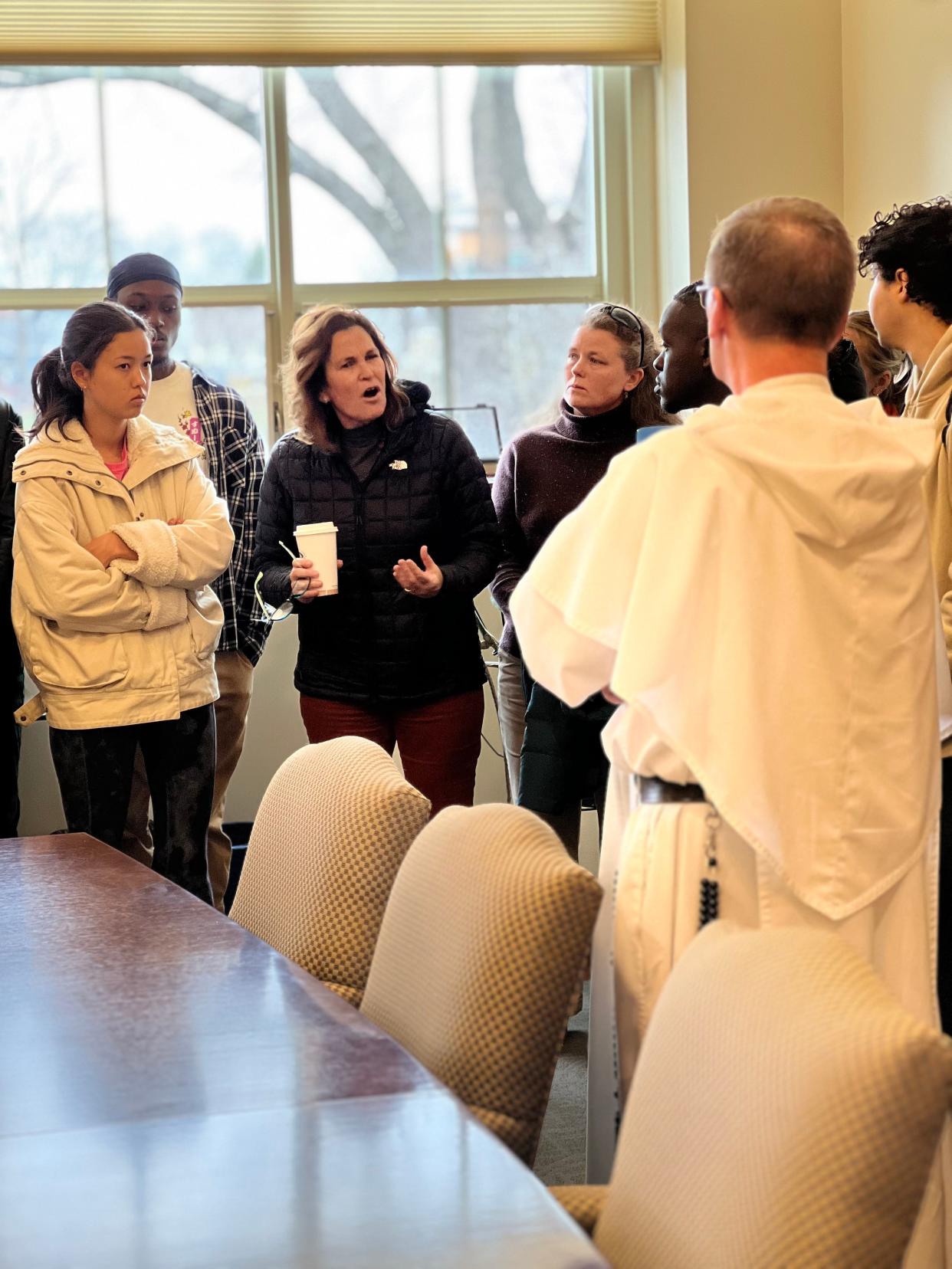 Alison Caplan, an associate professor of world languages, addresses Providence College's president, the Rev. Kenneth Sicard, as part of a group that delivered letters seeking greater acceptance of the LGBTQ+ community on campus.