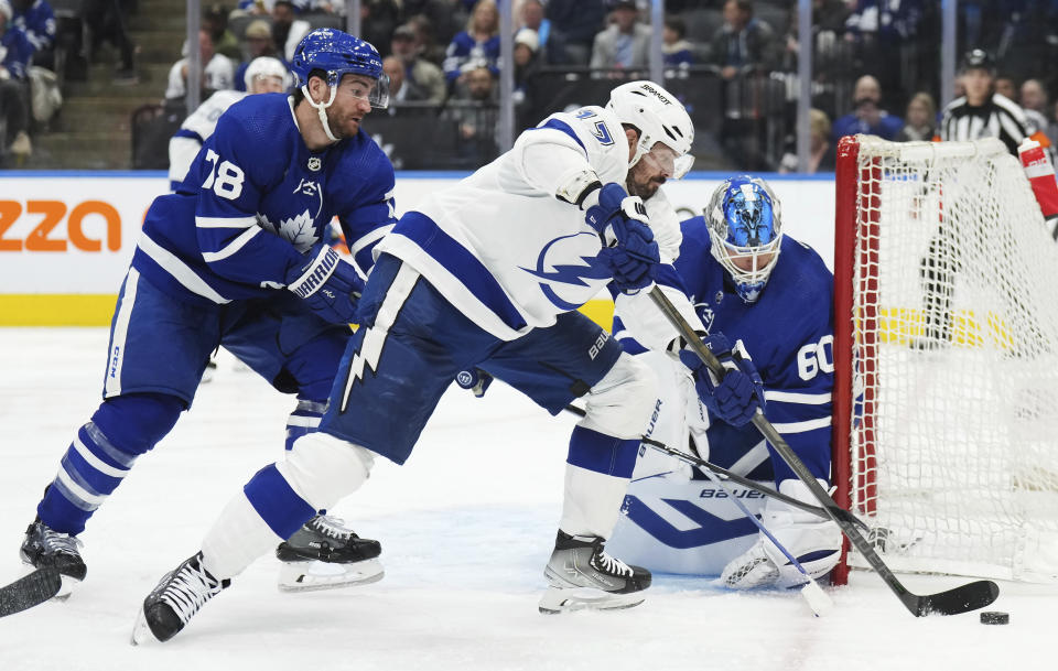 Toronto Maple Leafs goaltender Joseph Woll (60) stops Tampa Bay Lightning left wing Alex Killorn (17) as Maple Leafs defenseman TJ Brodie (78) defends during the third period of Game 1 of a first-round NHL hockey playoff series Tuesday, April 18, 2023, in Toronto. (Nathan Denette/The Canadian Press via AP)