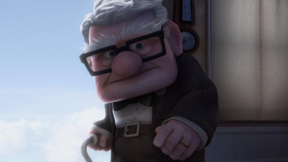 Carl Fredricksen stands in his doorway in Up