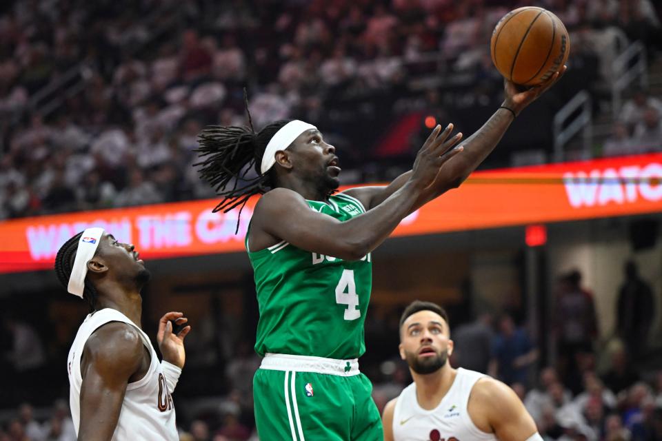 Celtics guard Jrue Holiday goes to the basket between Cavaliers guards Caris LeVert (left) and Max Strus in the second quarter of Game 4 of the Eastern Conference semifinals, May 13, 2024, in Cleveland.