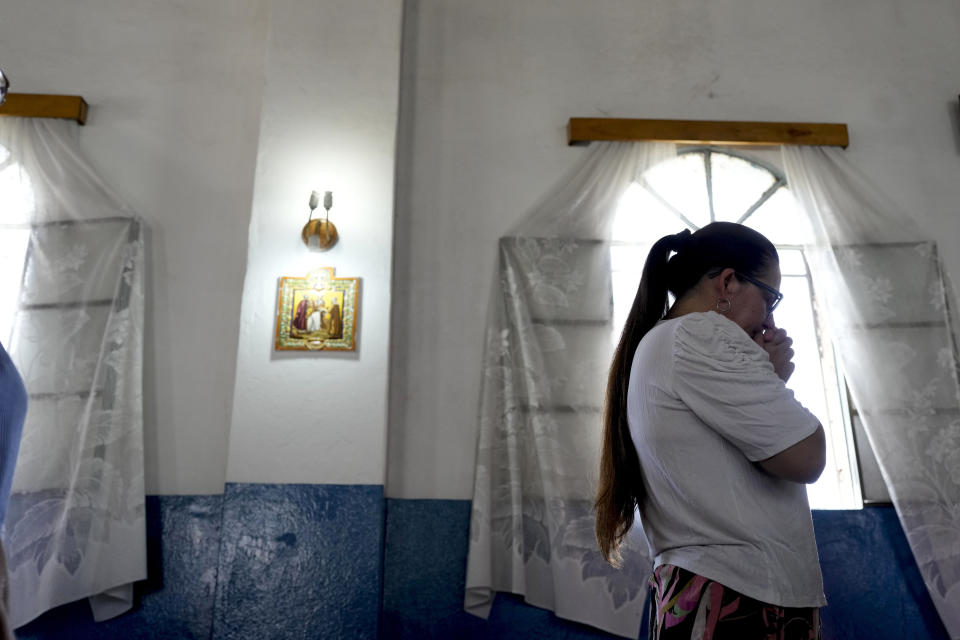 A woman prays during a Mass at the "Mama Antula" parish church, named for María Antonia de Paz y Figueroa, on the outskirts of Buenos Aires, Argentina, Sunday, Jan. 28, 2024. "Mama Antula", a Catholic laywoman who lived in 18th century Argentina and joined the Jesuits in their evangelical mission throughout the South American country, will become the first female saint from Argentina on Sunday, Feb. 11. (AP Photo/Natacha Pisarenko)