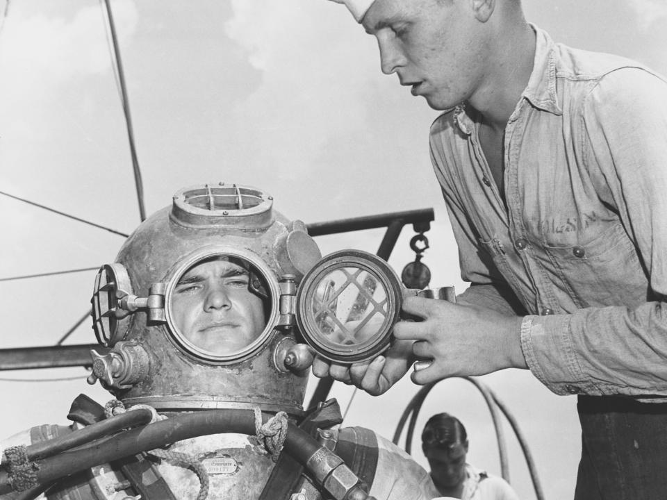 A US naval diver preparing for a dive in 1955.