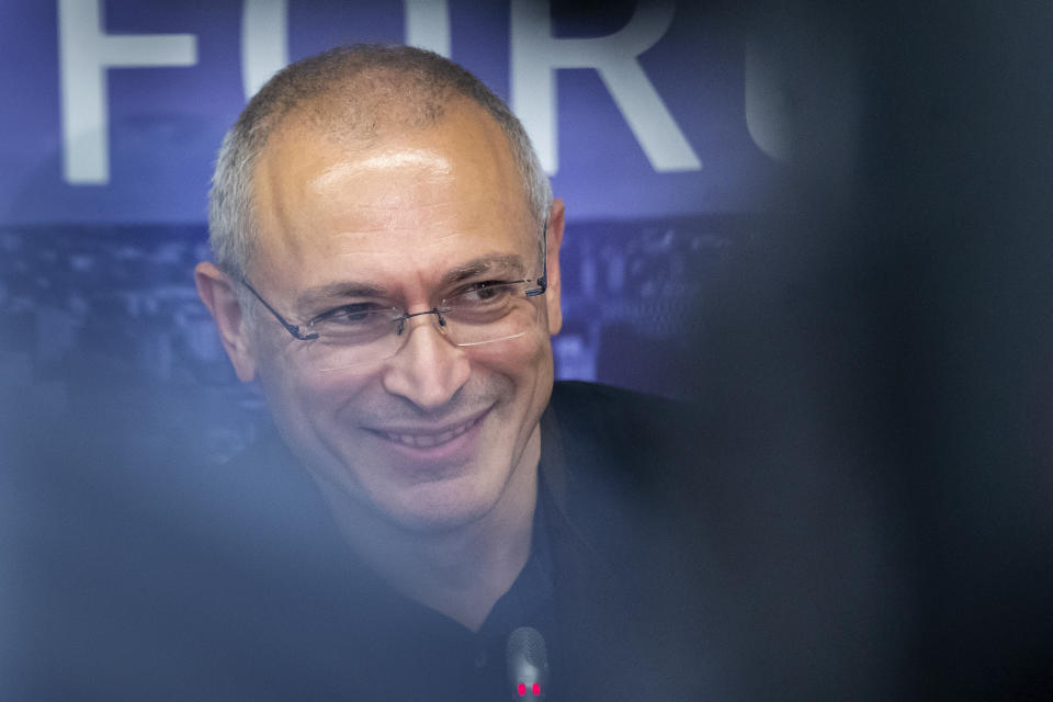 FILE - In this Aug. 20, 2021, file photo, Russian opposition figure and former owner of the Yukos Oil Company Mikhail Khodorkovsky smiles during a news conference with Lithuania's Minister of Foreign Affairs Gabrielius Landsbergis after Vilnius Russia Forum at the "Esperanza" hotel in Paunguriai village, Trakai district west of the capital Vilnius, Lithuania. Khodorkovsky, a Putin critic who moved to London after spending 10 years in prison on charges widely seen as political revenge. (AP Photo/Mindaugas Kulbis, File)