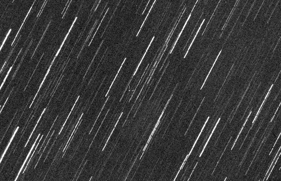 The asteroid 2013 QR1 (in center) is seen against star streaks in this image captured by the Virtual Telescope Project on Aug. 23, 2013. The asteroid was discovered on Aug. 16 and is about 250 meters wide.