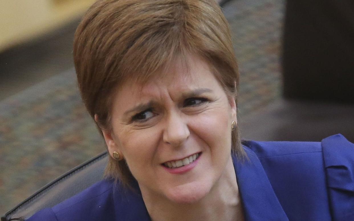 Scottish First Minister, Nicola Sturgeon reacts as she attends First Ministers Questions at Holyrood - Getty Images Europe