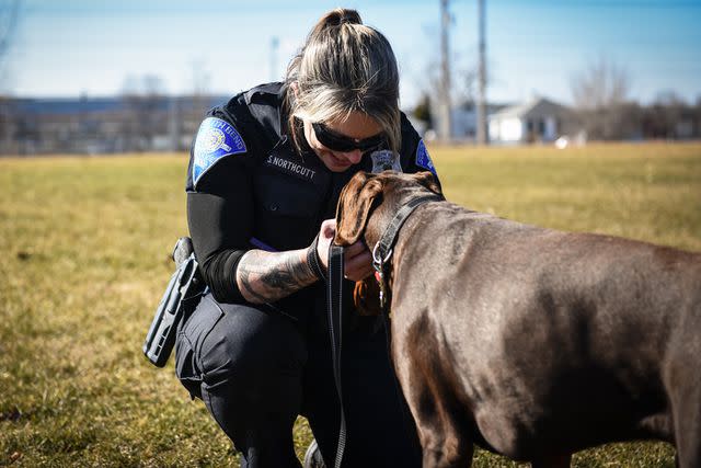 <p>South Bend Police Department/Facebook</p> South Bend Police Department officer Stephanie Northcutt with the dog she rescued and adopted, Zeus the Doberman