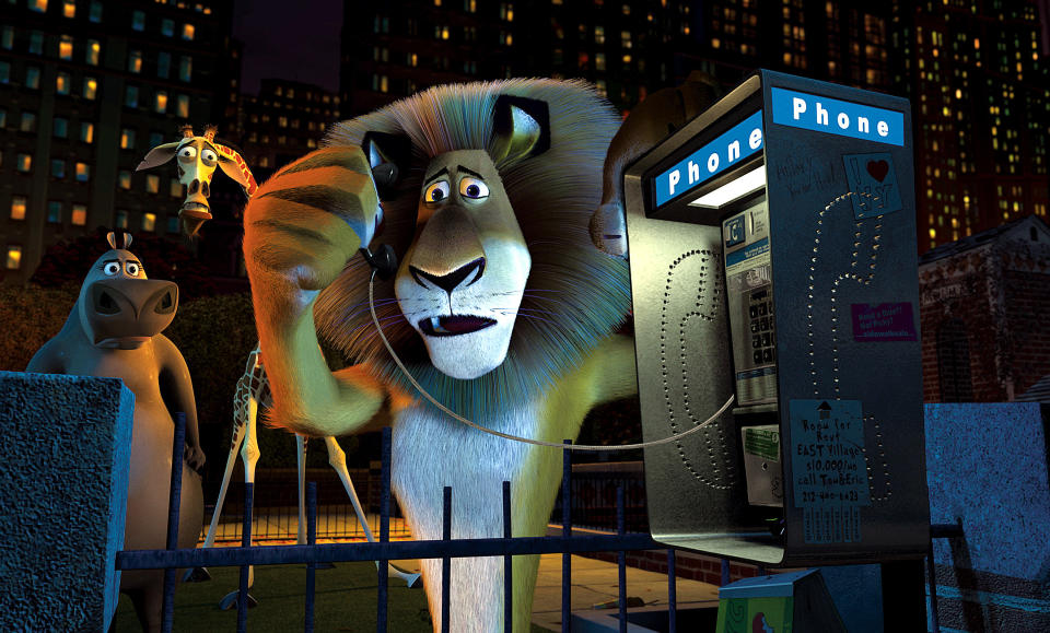 Alex the lion holding a phone