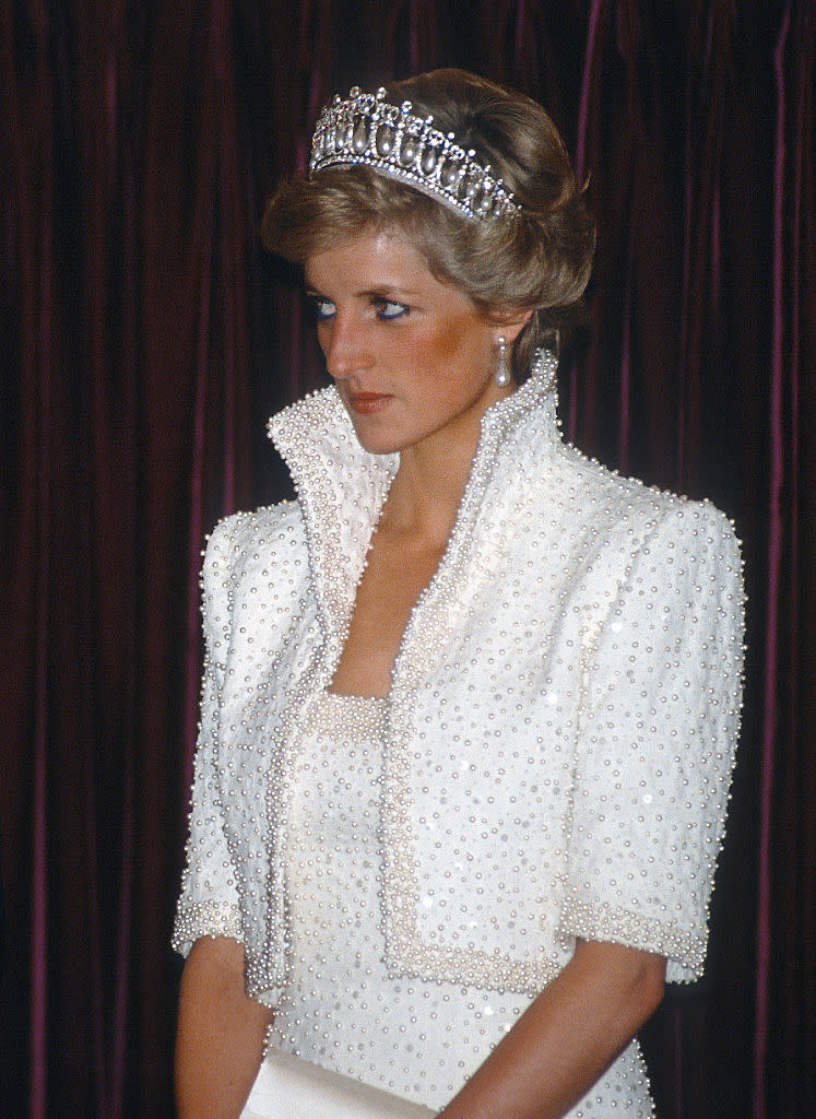 Diana, Princess of Wales wears the Cambridge Lover's Knot tiara and a white outfit by Catherine Walker known as the 'Elvis Look' during a tour of Hong Kong on November 10, 1989. (Photo: Getty)