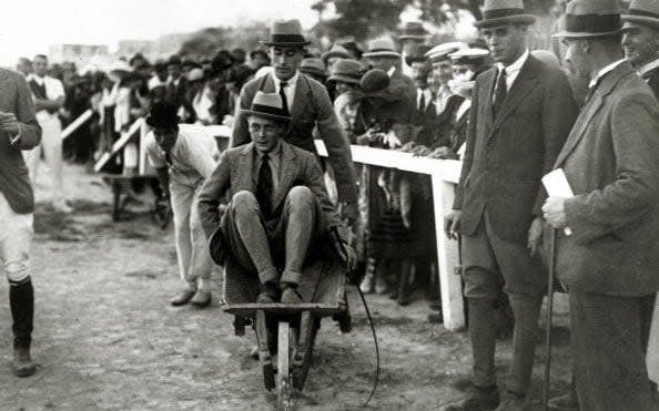 Prince Edward rides in a wheelbarrow pushed by Louis Mountbatten at a polo gymkhana in Malta, 1921 - Popperfoto