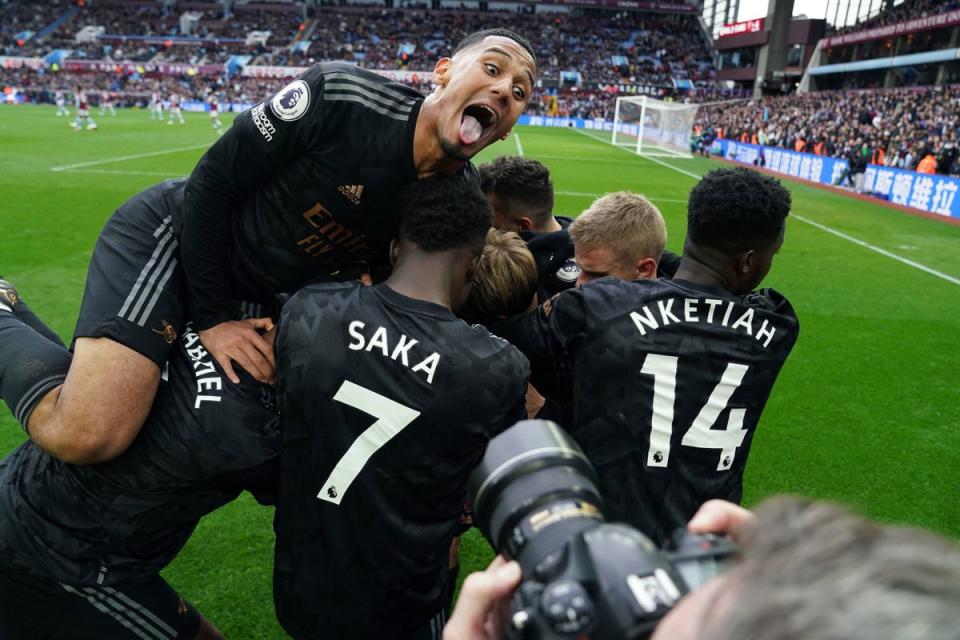 Arsenal's Jorginho (hidden) and team mates celebrate their sides third goal, an own goal by Aston Villa goalkeeper Emiliano Martinez during the Premier League match at Villa Park, Birmingham. (PA)