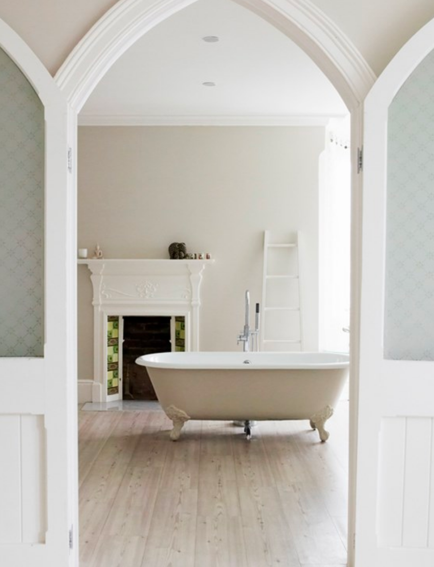 view through doorway into bath room with claw foot tub and grey walls