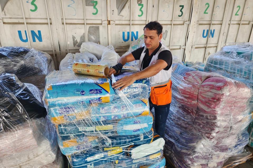 An UNRWA worker prepares to distribute aid (Copyright 2023 The Associated Press. All rights reserved.)
