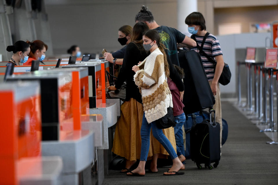 Passengers wear face masks due to Covid as they line up at the Jetstar check in terminal at Sydney Domestic Airport in Sydney.