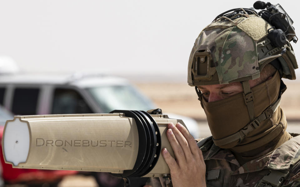 In this Jan. 27, 2021, handout image released by the U.S. Air Force, a soldier with the U.S. Air Force's 378th Air Expeditionary Wing trains members of the Royal Saudi Air Force Police Wing how to use equipment to counter drone attacks at at Prince Sultan Air Base near Riyadh, Saudi Arabia. Yemen's Houthi rebels on Wednesday, Feb. 10, 2021, targeted Abha International Airport in southwestern Saudi Arabia, causing a civilian plane on the tarmac to catch fire, the kingdom's state television reported, an attack that threatens to escalate Yemen's grinding war. Authorities initially suspected the attack was carried out by a drone. (U.S. Air Force/Senior Airman Leala Marquez, via AP)