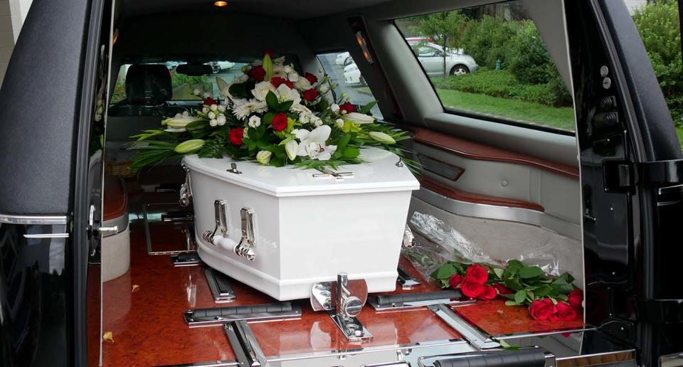 closeup shot of a colorful casket in a hearse or chapel before funeral or burial at cemetery