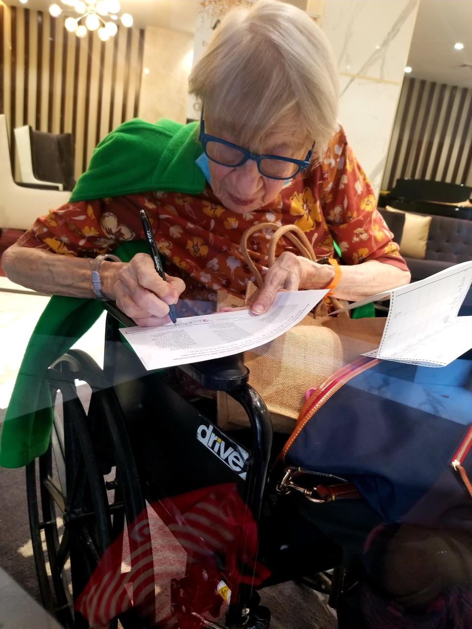 Claire Campbell took this photograph through a window at The Riverside Premier Rehabilitation and Healing Center in Manhattan as her mother Grace Campbell filled out her 2020 absentee ballot during COVID lockdown.
