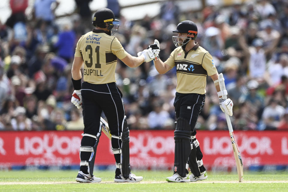 New Zealand's Martin Guptill, left, and Kane Williamson gesture as they bat during the second T20 cricket international between Australia and New Zealand at University Oval In Dunedin, New Zealand, Thursday, Feb. 25, 2021. (Andrew Cornaga/Photosport via AP)