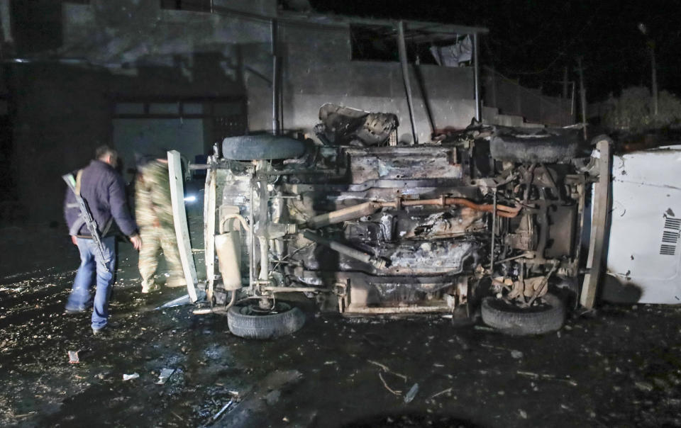 Citizens inspect a car destroyed during a shelling by Azerbaijan's artillery during a military conflict in Stepanakert, the separatist region of Nagorno-Karabakh, Friday, Oct. 23, 2020. Heavy fighting raged Friday over Nagorno-Karabakh even as top diplomats from Armenia and Azerbaijan visited Washington for negotiations on settling the neighboring countries' decades-long conflict. (AP Photo)