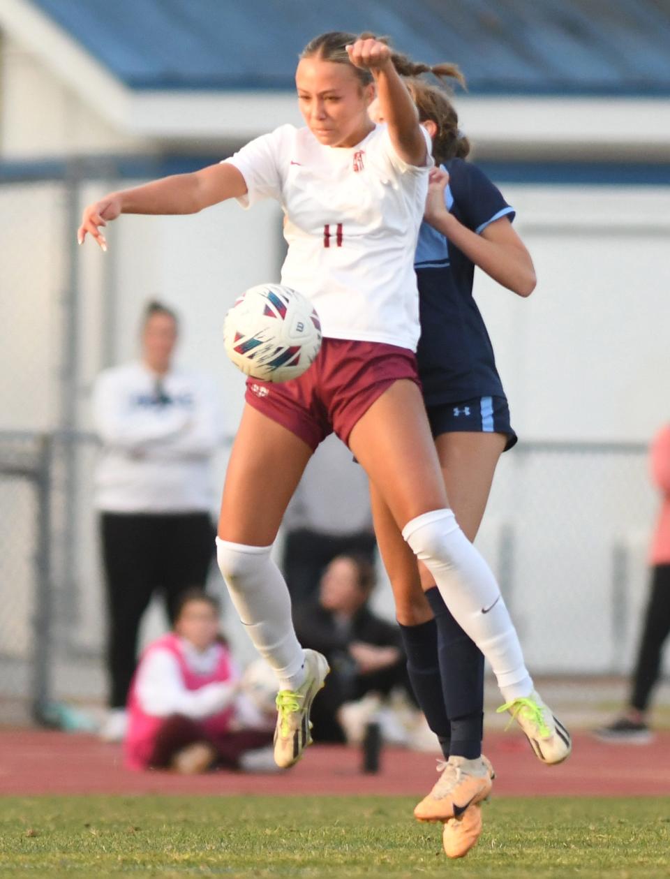 Ashley's #11 Karina Peat goes up to get control of the ball as Hoggard took on Ashley Tuesday March 26, 2024 at Scott Braswell Stadium in Wilmington, N.C. Ashley won 3-1. KEN BLEVINS/STARNEWS