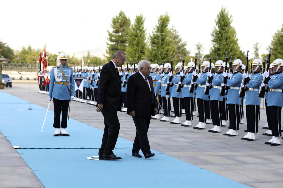 Turkey's President Recep Tayyip Erdogan, left, and Palestinian President Mahmoud Abbas review a military honour guard during a welcome ceremony in Ankara, Turkey, Tuesday, Aug. 23, 2022. Abbas in Turkey for a two-day state visit.(AP Photo/Burhan Ozbilici)