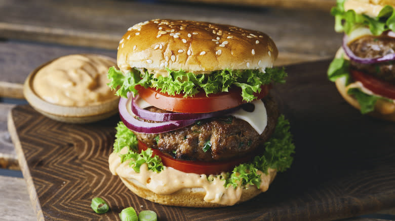 cheeseburger and bowl of burger sauce