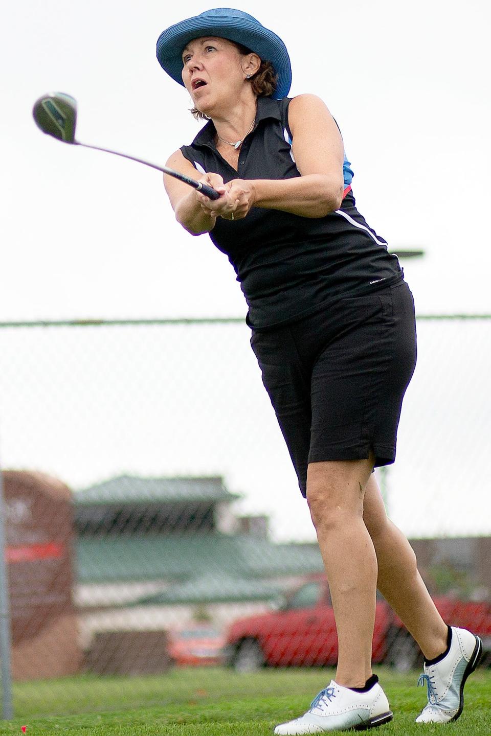 Lorie Larsen eyes her drive from the third tee at Bunker Links during the opening round of the Galesburg Women' All-City Golf Tournament on Tuesday, July 21, 2020.