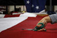 <p>A worker trims an American flag at the FlagSource facility in Batavia, Illinois, U.S., on Tuesday, June 27, 2017. (Photo: Jim Young/Bloomberg via Getty Images) </p>