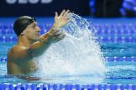 Caeleb Dressel reacts after winning the men's 50 freestyle during wave 2 of the U.S. Olympic Swim Trials on Sunday, June 20, 2021, in Omaha, Neb. (AP Photo/Jeff Roberson)