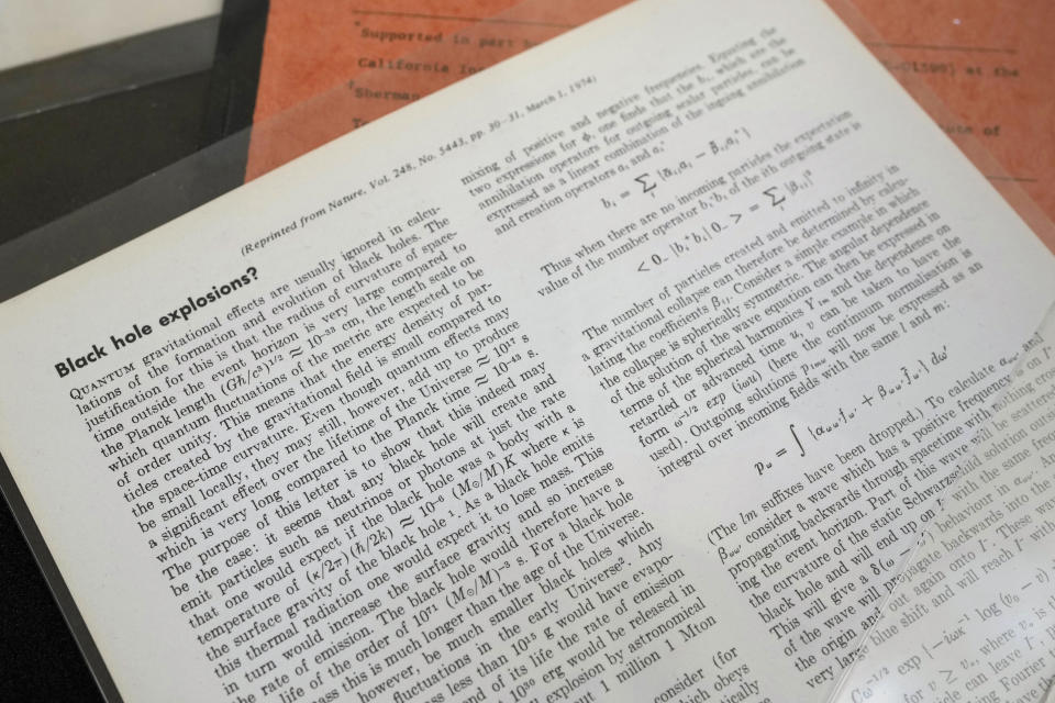 Examples of Professor Stephen Hawking's work Black Hole Explosions which predicted Hawking Radiation, along with copies of various scientific papers which have been acquired by the Science Museum Group, in London, Wednesday, May 26, 2021. Science Museum Group and Cambridge University Library will announce that they have acquired the historic contents of Professor Stephen Hawking's office (going to SMG) and his archive (going to CUL). (AP Photo/Kirsty Wigglesworth)