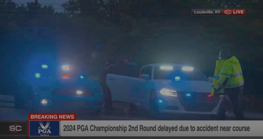 In this still image made from video provided by ESPN, Masters champion Scottie Scheffler is put into a police car after being handcuffed near Valhalla Golf Club, site of the PGA Championship golf tournament, early Friday, May 17, 2024. (ESPN via AP)