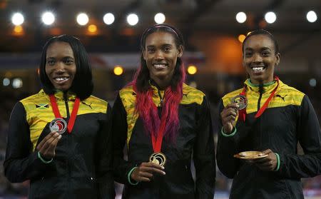 Stephanie Mcpherson (C) of Jamaica holds her gold medal beside compatriots Novlene Williams-Mills (L), silver medalist, and Christine Day (R), bronze medalist, after the Women's 400m final at the Commonwealth Games in Glasgow, Scotland, July 29, 2014. REUTERS/Jim Young