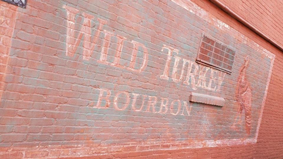 For country music TV series "George & Tammy," this brick wall on Second Street in downtown Wilmington was outfitted with a "faded" sign for Wild Turkey bourbon.