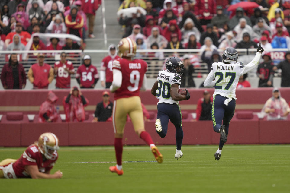Seattle Seahawks' Mike Jackson (30) returns a blocked field goal for a touchdown next to Tariq Woolen (27) past San Francisco 49ers' Mitch Wishnowsky, left, and place kicker Robbie Gould (9) during the second half of an NFL football game in Santa Clara, Calif., Sunday, Sept. 18, 2022. (AP Photo/Tony Avelar)