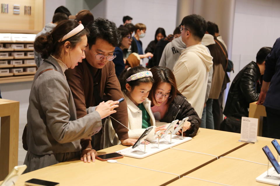 A customer experiences Apple's iPhone 15 series smartphones at Asia's largest Apple flagship store in Shanghai, China, on March 23, 2024.  (Photo courtesy of Costfoto/NurPhoto, Getty Images)