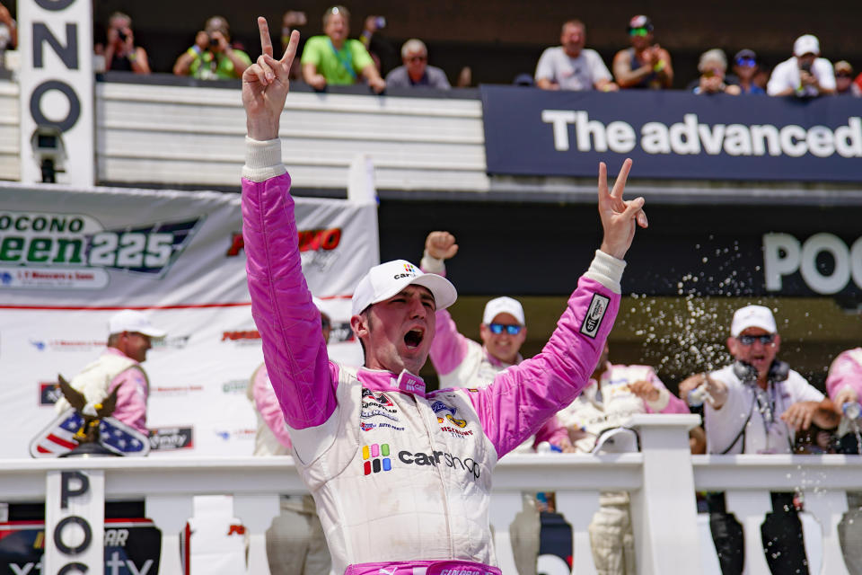 Austin Cindric celebrates after winning a NASCAR Xfinity Series auto race at Pocono Raceway, Sunday, June 27, 2021, in Long Pond, Pa. (AP Photo/Matt Slocum)