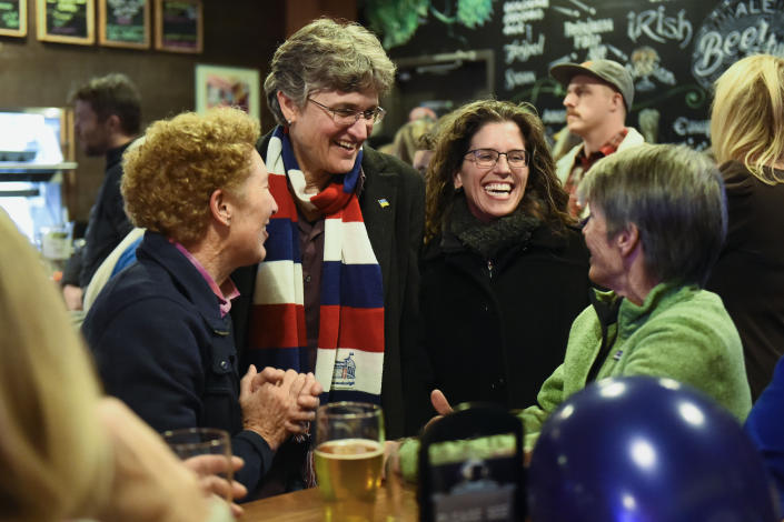 Jamie McLeod-Skinner, Democratic candidate candidate for Oregon's 5th Congressional District, left with scarf, greets supporters with her wife, Cass Skinner-McLeod, at an election watch party at the Silver Moon Brewery Tuesday, Nov. 8, 2022, in Bend, Ore. (AP Photo/Andy Nelson)