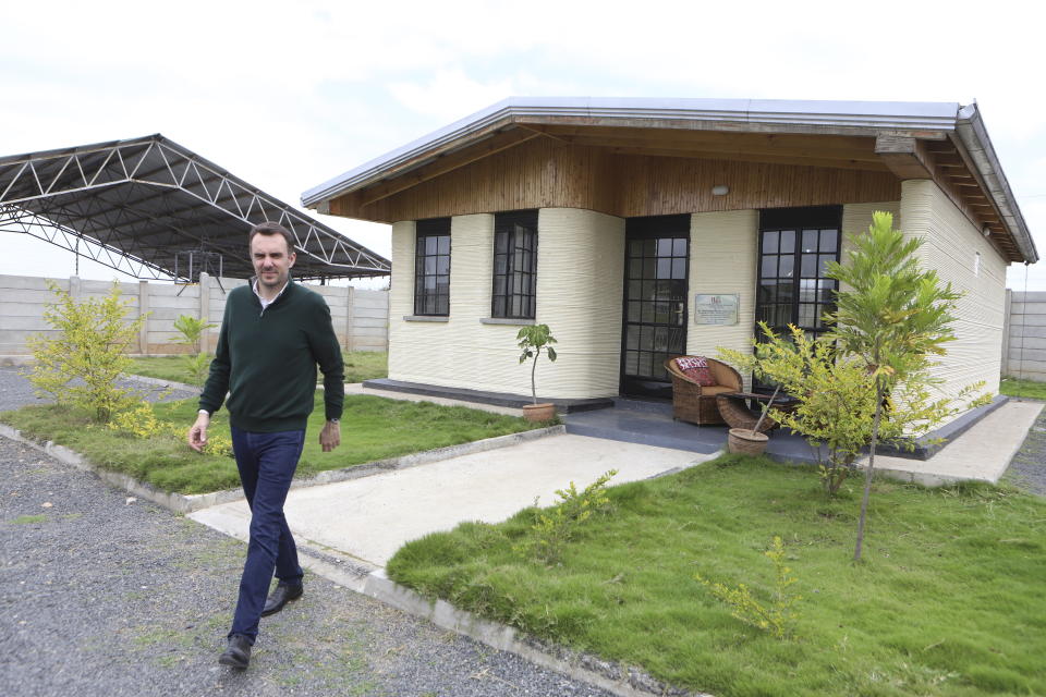Francois Perrot, CEO of 14Trees company, walks out of the house that was built using 3D printing technology in Mlolongo, Machakos county, Kenya, Tuesday, May 28, 2024. Kenya's urban population makes up a third of the country's total population of more than 50 million. Of those living in urban areas, 70% live in informal settlements marked by lack of basic infrastructure, according to UN-Habitat. (AP Photo/Andrew Kasuku)