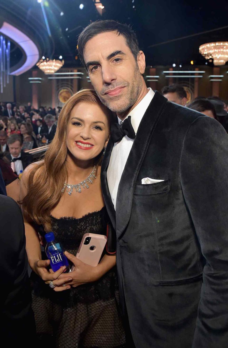 Isla Fisher (L) and Sacha Baron Cohen attend FIJI Water at the 76th Annual Golden Globe Awards on January 6, 2019 at the Beverly Hilton in Los Angeles, California