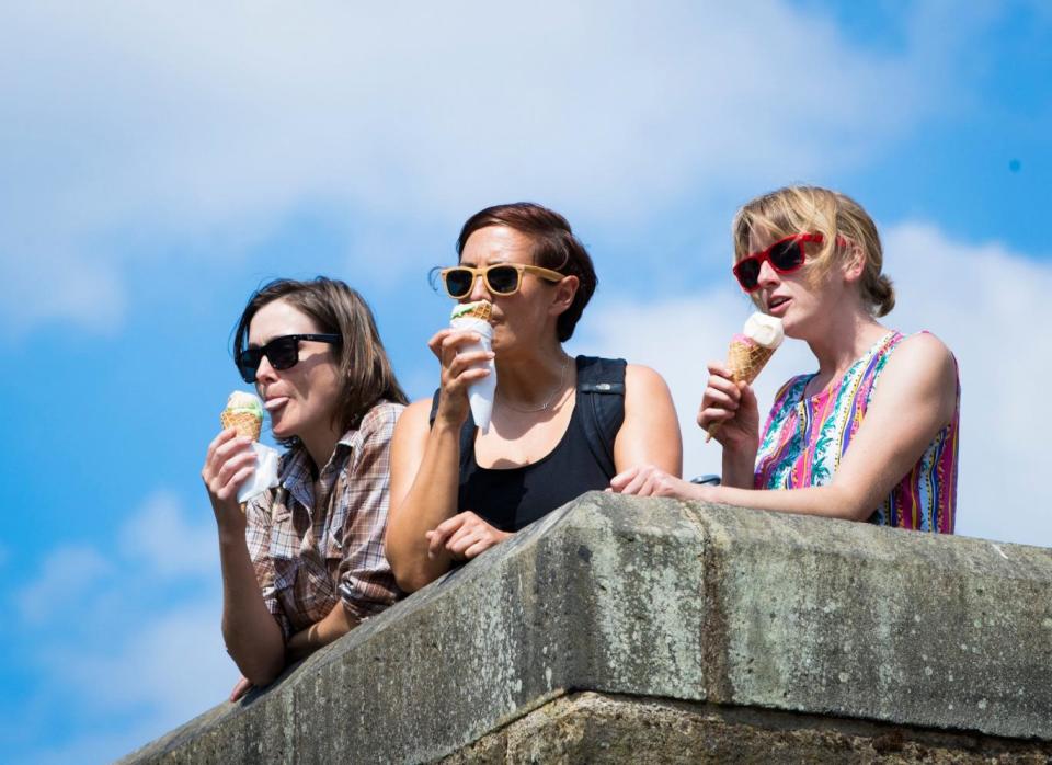 Women enjoy an ice cream in West Yorkshire (PA)