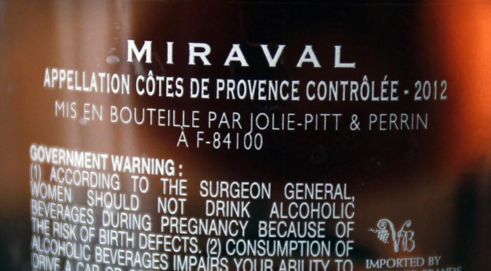 FILE - In this March 7, 2013 file photo, the names of Brad Pitt and Angelina Jolie are visible on a bottle of Miraval, Cote de Provence rose wine displayed in Paris. Jasper Russo, the fine wine buyer for Sigel's wine and spirits store in Dallas, recently held a tasting of celebrity wines, including Miraval, a partnership between Jolie and Pitt and the Perrin French winemaking family. Miraval retails for about $24.99 and is made from grapes grown at Chateau Miraval, Pitt and Jolie's place in the south of France. (AP Photo/Remy de la Mauviniere, File)
