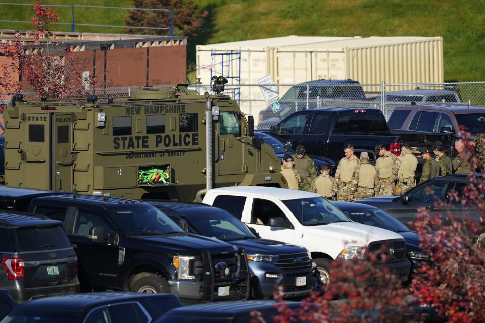 Law enforcement personnel are staged in a school parking lot as a manhunt continues in the aftermath of a mass shooting in Lewiston, Maine, Friday, Oct. 27, 2023. Shocked and fearful Maine residents are keeping to their homes for a second night as hundreds of police and FBI agents search intently for Robert Card, a U.S. Army reservist authorities say fatally shot several people at a bowling alley and a bar. (AP Photo/Matt Rourke)