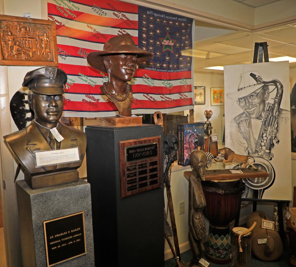 Works of art, including a bust on the left of a local member of the Tuskegee Airmen, fill a room at the African American Museum of the Arts in DeLand.