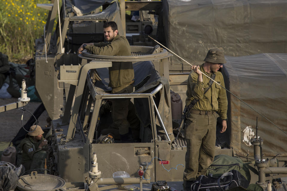 Israeli soldiers sit on top of mobile artillery near the border with Gaza, in southern Israel, Wednesday, March 27, 2019. (AP Photo/Tsafrir Abayov)