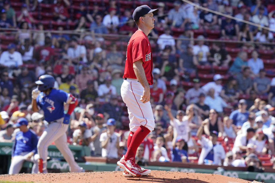 Toronto Blue Jays' Vladimir Guerrero Jr., left, runs toward home plate after hitting a two-run home run off Boston Red Sox's Ryan Weber, right, in the seventh inning of a baseball game, Sunday, June 13, 2021, in Boston. The Blue Jays won 18-4. (AP Photo/Steven Senne)